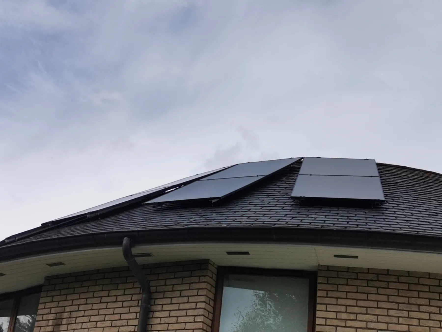 Panels following the roofline against the sky