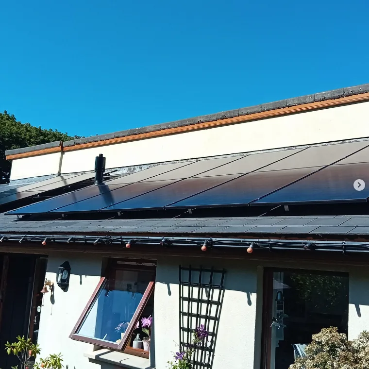 Solar panels on a white rendered house