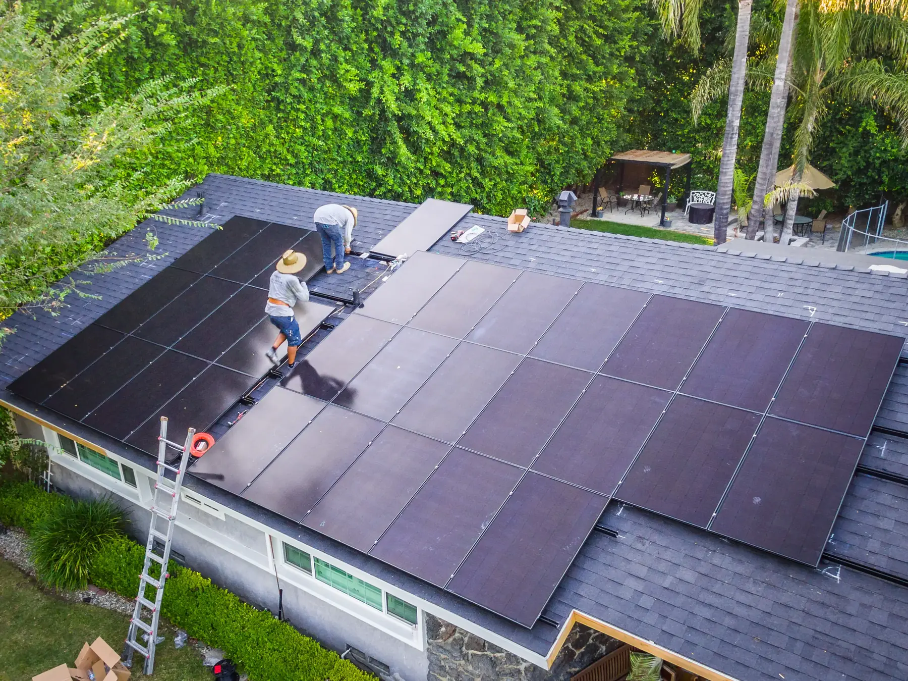 Installation team fitting panels, seen from above